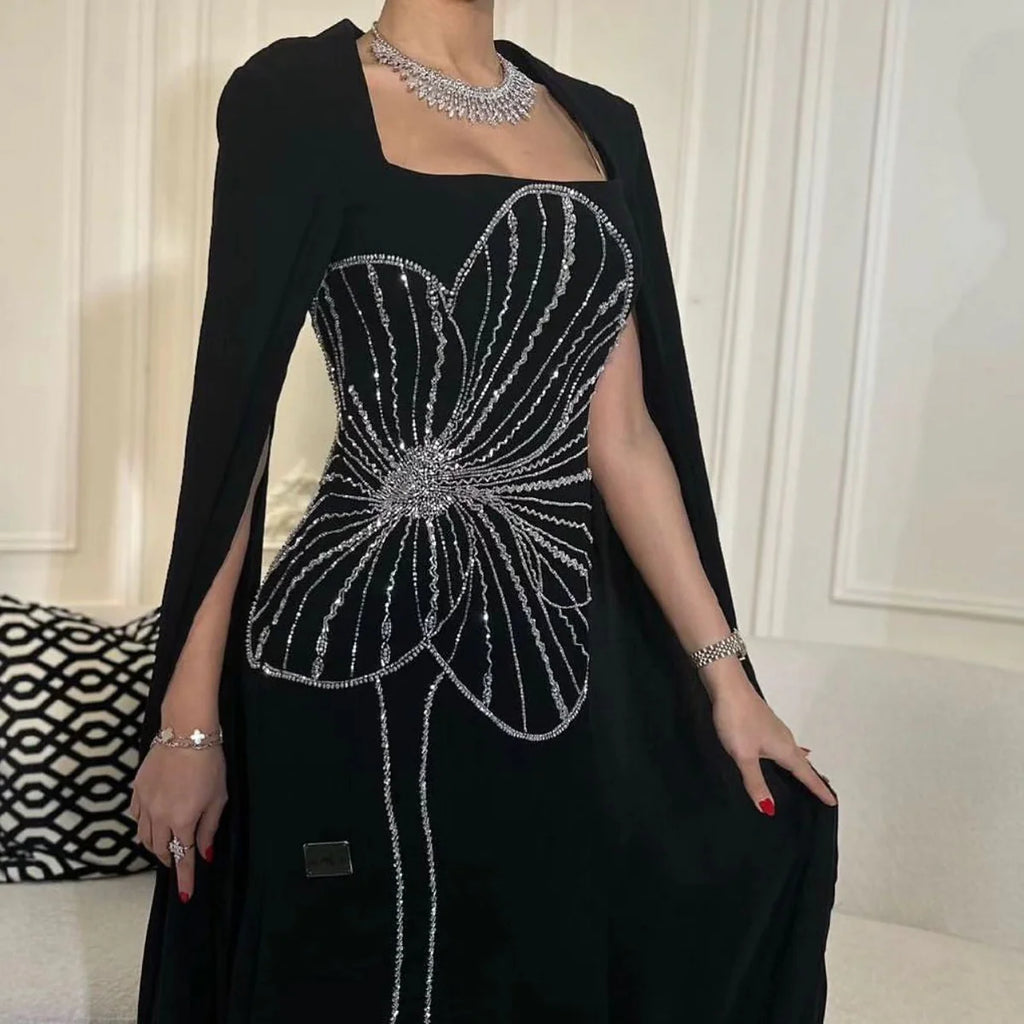 Robe noire élégante avec cape et broderie scintillante